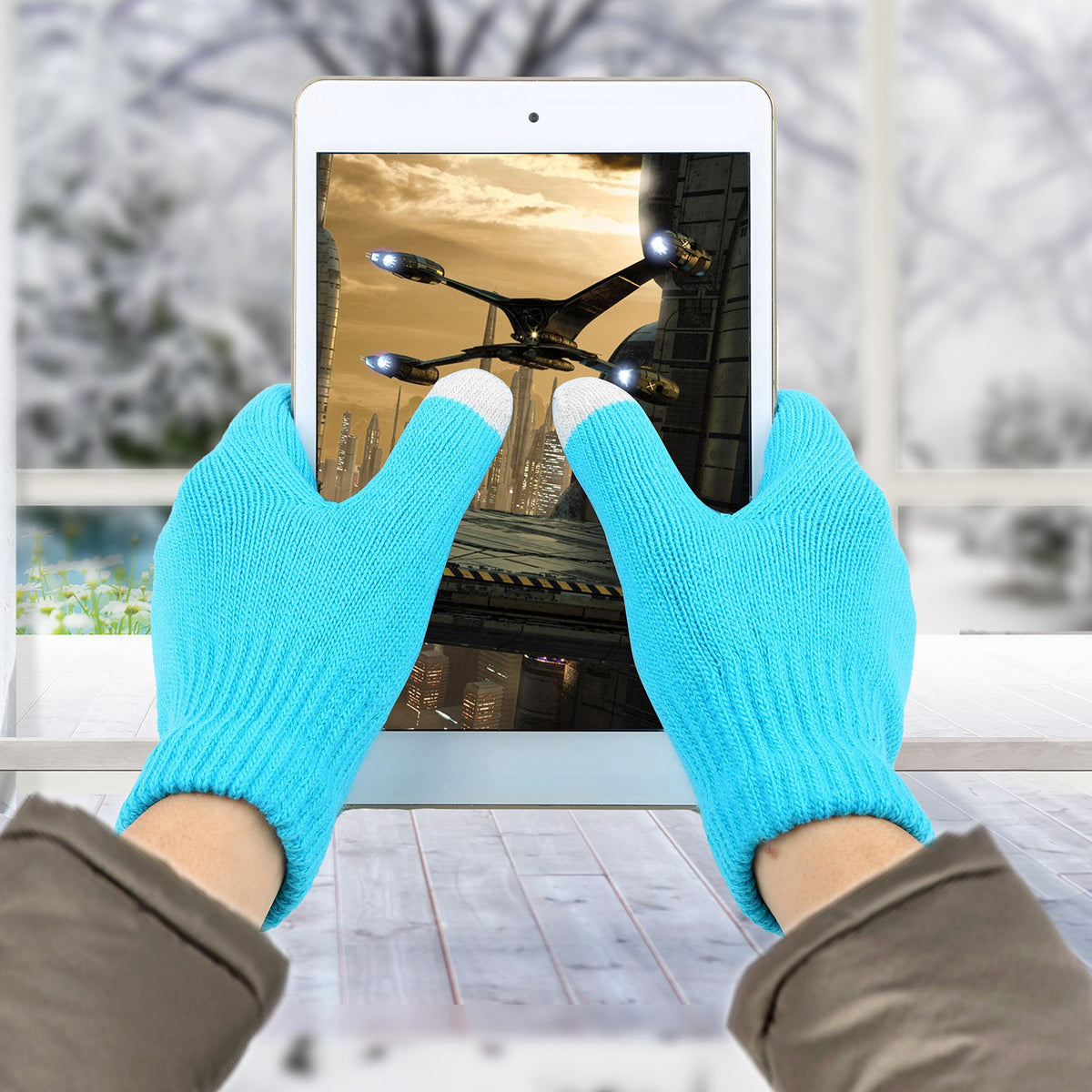 Aqua blue touchscreen gloves holding a tablet