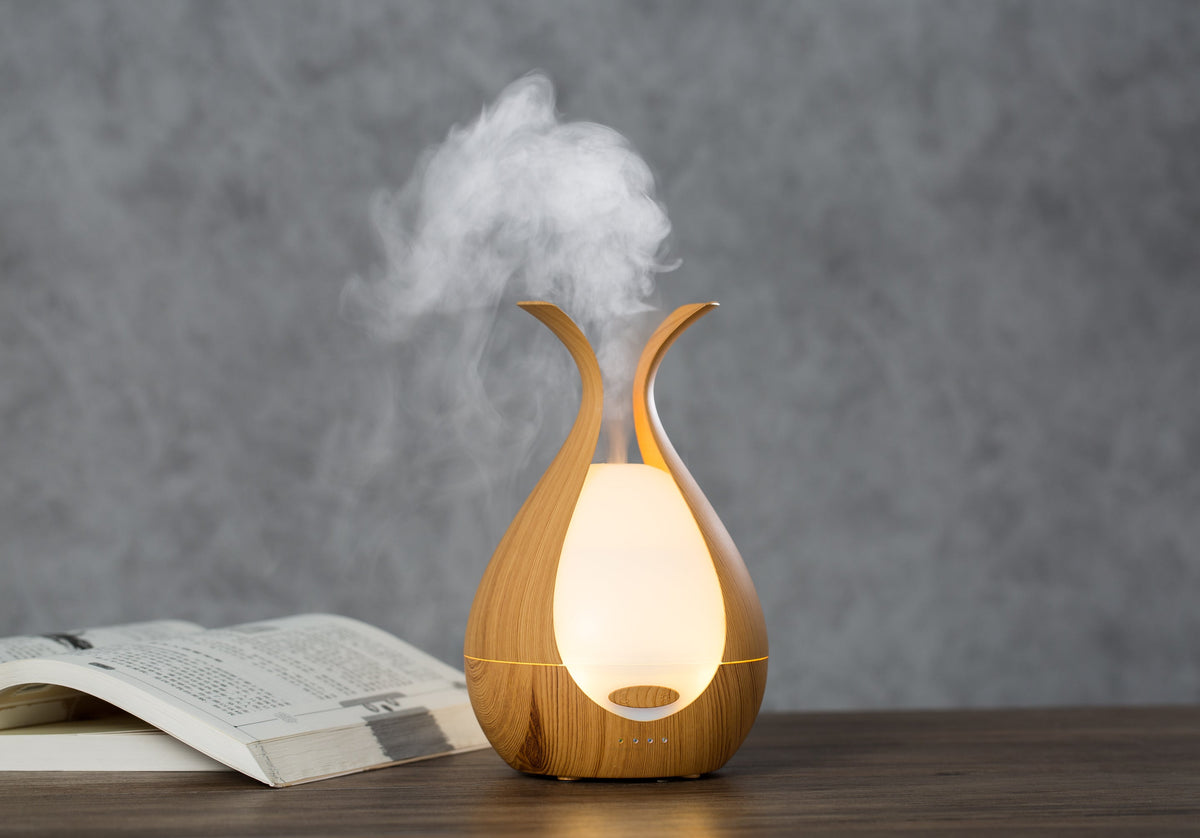 Timeless diffuser misting on a bedside table