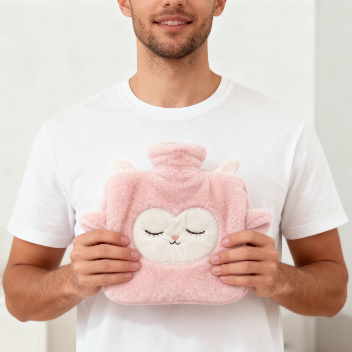 Man holding the plush lamb hot water bottle for scale